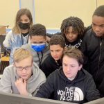 students gathered around a computer screen