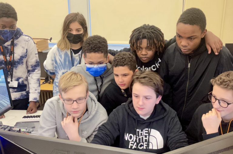 students gathered around a computer screen